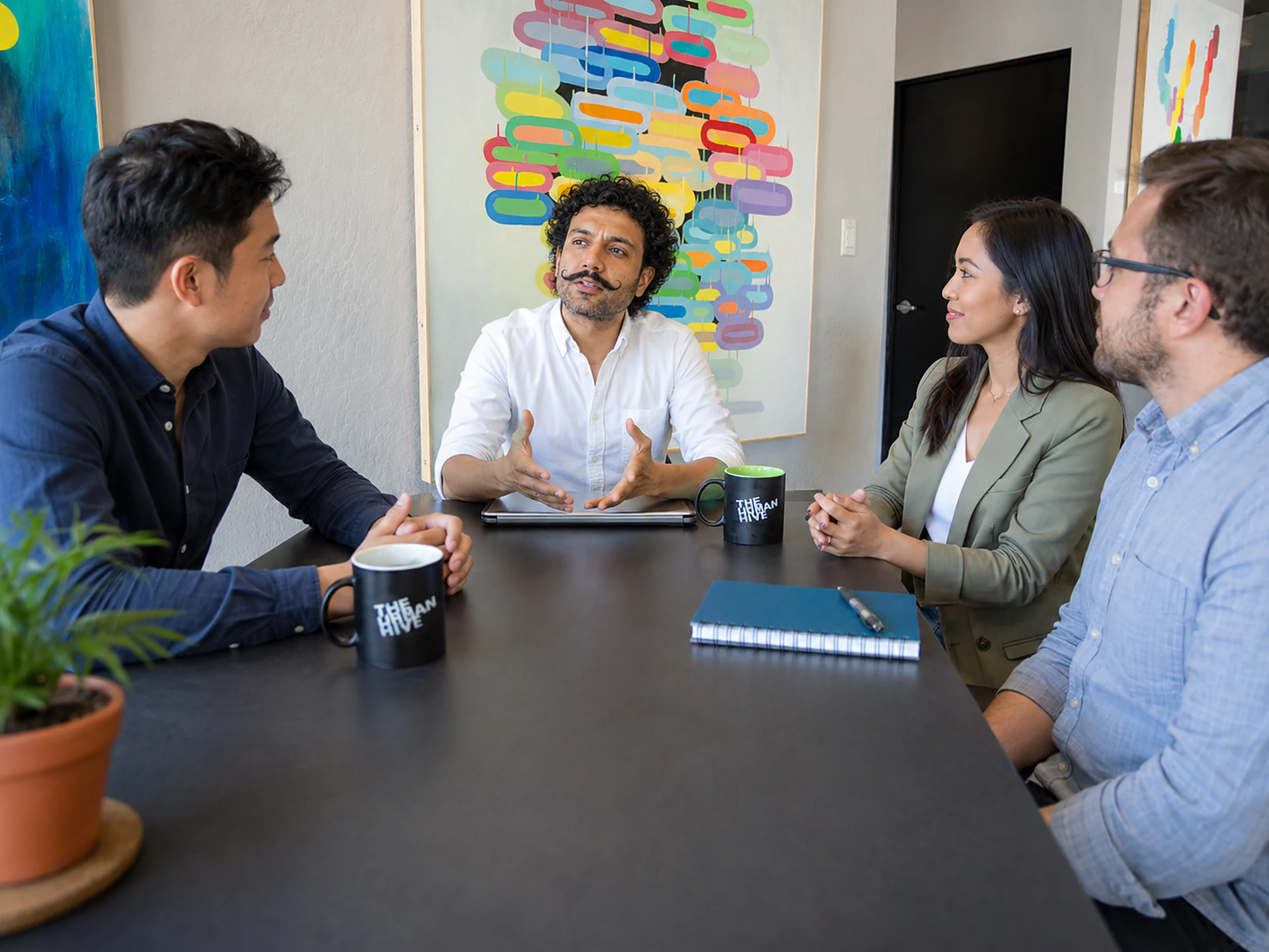 Beacon Digital PR team collaborating on a media campaign strategy around a conference table